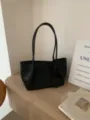 Black woven leather tote bag with shoulder straps and heart pendant for daily use. - Black Woven Bag