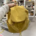 Casual yellow nylon backpack with drawstring and flap closure, lightweight daily commuter bag. - Yellow