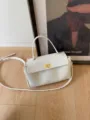 Detail view of retro PU leather handbag, elegant top-handle shoulder crossbody bag for women. - White