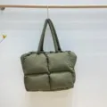 Detail shot of green quilted puffer tote bag, soft padded cloud shoulder bag, spacious design. - Army Green