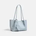 Light blue woven leather shoulder tote bag with heart pendant for casual daily wear - Blue Woven Bag