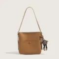 Brown PU leather shoulder bag with cute doll pendant, stylish underarm bag for women. - No Pendant / Brown