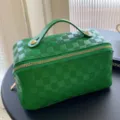 Green PU leather cosmetic bag with top handle and spacious interior for daily travel and storage. - 25x12x12cm / Green Makeup Bag