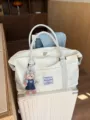 Large capacity waterproof travel duffel bag with trolley sleeve and cute plush bear pendant. - 50x18x35cm / Milk White
