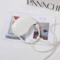 White bean shaped shoulder bag, chic crescent handbag with round handle and marble bead detail. - White