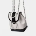 Black and white leather backpack with metallic chain straps and chic flap design. - Black and White Chain Backpack