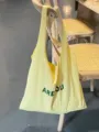 Light yellow canvas tote bag, casual lightweight shoulder shopping bag with green letter print. - Yellow