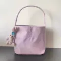 Detailed view of the taro purple nylon underarm bag featuring delicate embroidery and cute pendant. - Purple