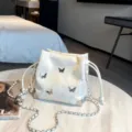White bucket bag with silver butterfly charms and chain strap, stylish crossbody bag for women - White