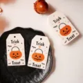 Detailed view of Halloween paper gift tags with cute pumpkin designs and festive text. - New 1 / 50 Pieces