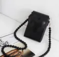 Black mini crossbody phone bag with 3D heart flap and beaded chain strap, stylish daily wear. - Black