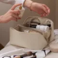 Large capacity PU cosmetic bag for women, portable travel organizer with compartments and pillow. - Off White