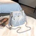 Silver 3D butterfly bucket bag with metallic chain strap and stylish drawstring closure. - Silver