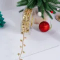 Cinta navideña dorada con relieve de estrellas, ideal para envolver regalos y decorar el árbol. - 2.5cm Dorado