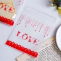 Cookie packaging bag detail showing red love print and clear self-adhesive plastic design. - Pack of 100 / Red Floral