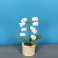 Handcrafted crochet lily of the valley flower detail view, cute knitted potted plant ornament decor. - White