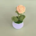 Handcrafted crochet rose flower detail shot, miniature potted plant ornament for desk decor. - Yellow
