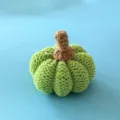 Handmade crochet pumpkin toy, cute knitted autumn decor ornament for Halloween party table. - Green