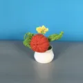Handmade crochet potted plant with cute fruit and flower design, perfect home and office decor. - Pumpkin