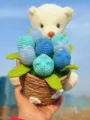 Handmade crochet white bear holding blue tulip flower bouquet, detailed wool craft for home decor. - Assorted