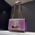Purple rhinestone chain shoulder bag with luxury crystal sparkle and gold skull clasp hardware. - Elegant Purple