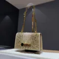 Detailed view of the luxury crystal rhinestone shoulder bag with stunning skull hardware clasp. - Stylish Gold