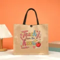 Close-up detail of the teacher appreciation jute tote bag featuring cute cartoon print. - Style 14
