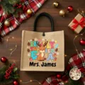 Custom Christmas jute tote bag with teacher graphic and personalized name, perfect gift. - Style 1