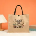 Jute tote bag featuring teacher life print, spacious design with black handles for daily use. - Style 11
