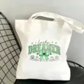 Gros plan du sac cabas en toile blanche avec lettres imprimées léopard vert et nœud. - Style Lucky DREAMER (06)