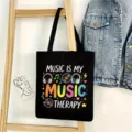 Bolso tote de lona negra vista detalle, estampado tema música, bolso de hombro casual diario. - Estilo Música 06