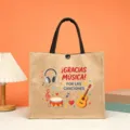 Detailansicht einer großen Jutetasche mit Musik Cartoon Druck und spanischem Text. - Musik Thema