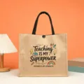 Detailed view of teacher theme jute tote bag with motivational quote print and black handles. - Style 4
