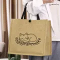 Detailed view of the cute cat line art and premium jute texture on this versatile retro tote bag. - Cat Style (10)