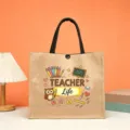 Close-up detail of the teacher theme jute tote bag featuring cute owl print and black handles. - Teacher Life Typographic Style (17)