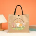Detail shot of jute tote bag featuring cute corgi graphic and warm Spanish blessing text print. - Style 8