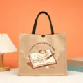 Detailed view of the burlap tote bag featuring a book and coffee design for teachers and reading. - Style 5