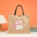 Burlap jute tote bag with black handles, featuring Mama Moma Spanish text print, durable grocery bag. - Style 3