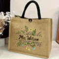 Custom name jute tote bag detail featuring elegant floral print and sturdy black handles. - Fresh Botanical Print (7)