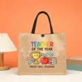 Teacher jute tote bag detail showing cute trophy, apple and colorful typography print. - Teacher of the Year Style (1)