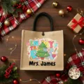 Detailed shot of custom burlap tote bag with Christmas tree print and teacher name. - Style 17
