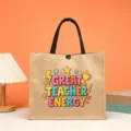 Jute tote bag detail showing creative teacher graphic print and durable black handles. - Great Teacher Energy Style (3)