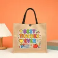 Detailed view of the burlap tote bag with teacher graphic, black handles and snap closure. - Best Teacher Style (1)