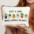 Close-up detail of white canvas zipper pouch featuring cute cactus prints and funny typography. - Cactus Style (011)