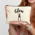 Close-up detail of the canvas makeup pouch with lipstick print and Glow text for daily use. - Glow Style (3)