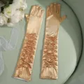 Detailed close-up of long satin pleated gloves in gold, elegant evening wear accessory. - One Size / Gold
