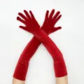 Detailed view of long red velvet gloves, elegant vintage stage performance accessory. - One Size / Red