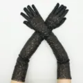 Close-up of long black sequined gloves, sparkly stretch mesh fabric for evening party costumes. - One Size / Black