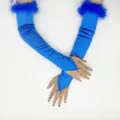 Detail view of blue satin long gloves featuring fluffy feather cuffs and finger loop design. - Blue