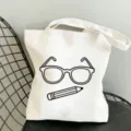 Detailaufnahme einer weißen Stofftasche mit niedlichem Brillen und Stift Motivprint. - 35x40cm / Einfache Brille und Bleistift Muster